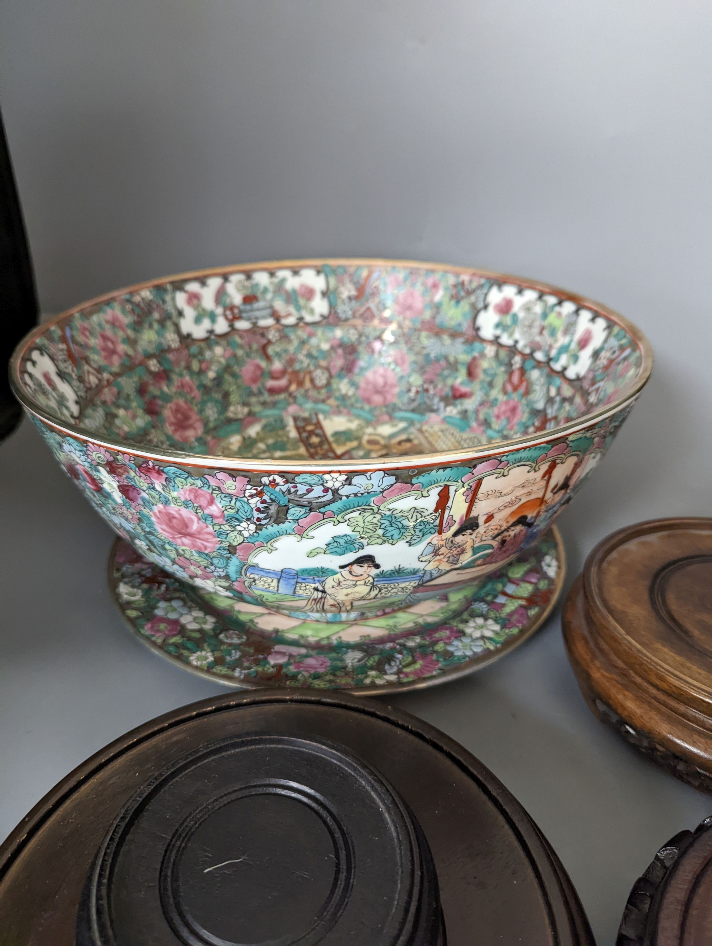 A Chinese famille rose bowl, plate and four stands, bowl 31 cms diameter.